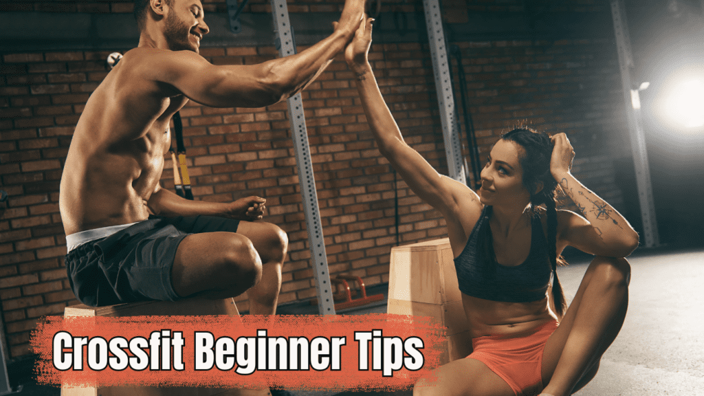 A man and a woman at the gym doing high five and a sign:Crossfit Beginner Tips