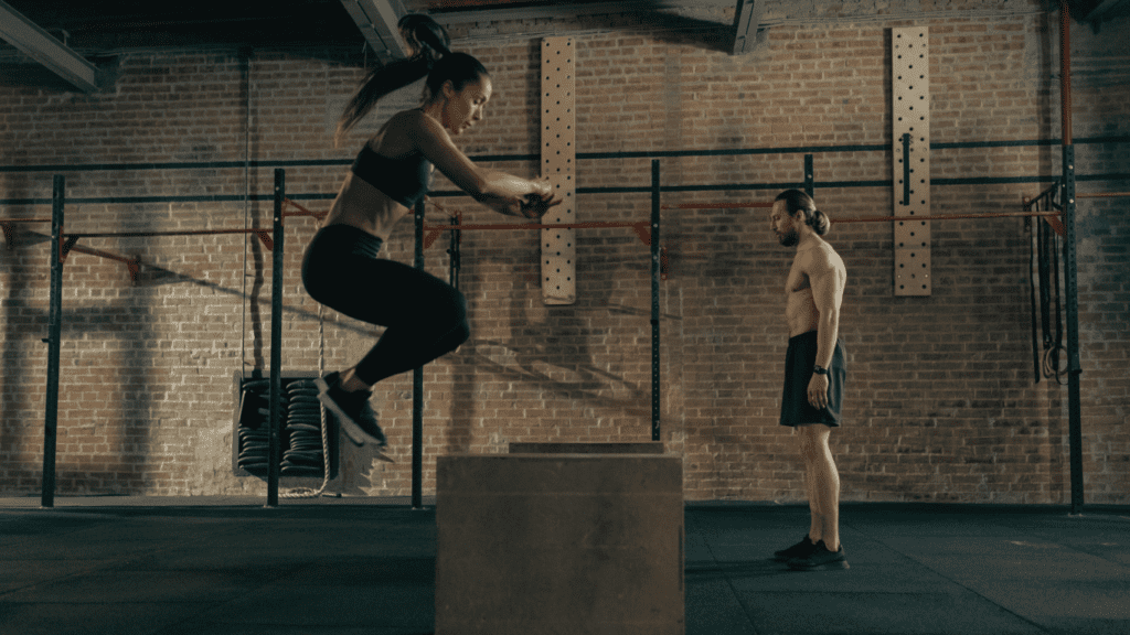 A Woman Jumping High At A Crossfit Gym