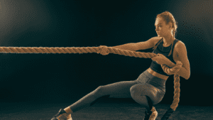 A Crossfit exercise:Pulling a rope performed by a woman at the gym