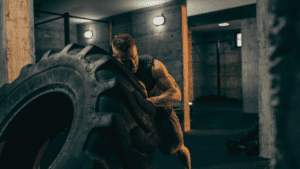 A Man Pushing A Tire Exercise As A Crossfit beginner tips 