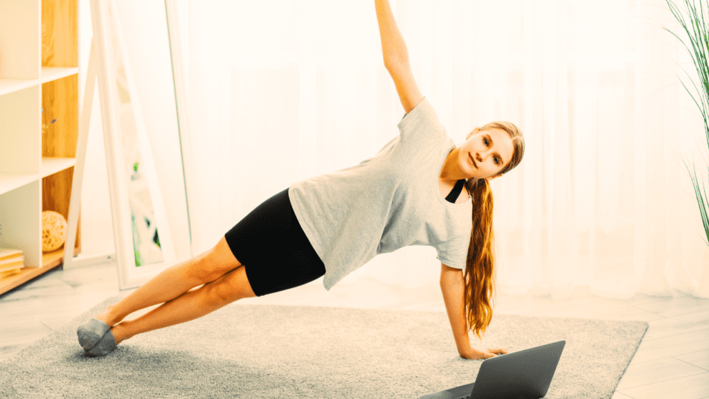 A Woman Doing Pilates Online At Her Home