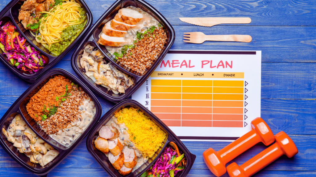 An Actual Fitness Meal Schedule With Food Boxes Of Healthy Foods And Some Light Weights Photo