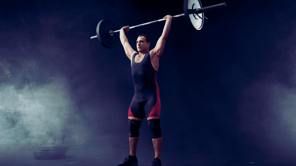 Powerlifter lifting a barbell above his head 