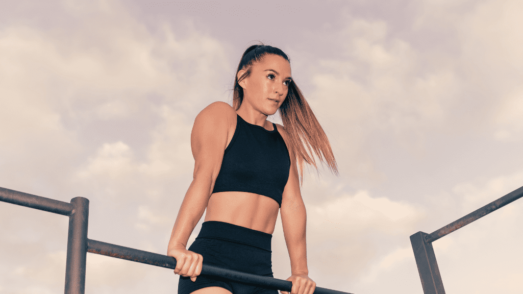 A Woman Training Calisthenics On A Bar