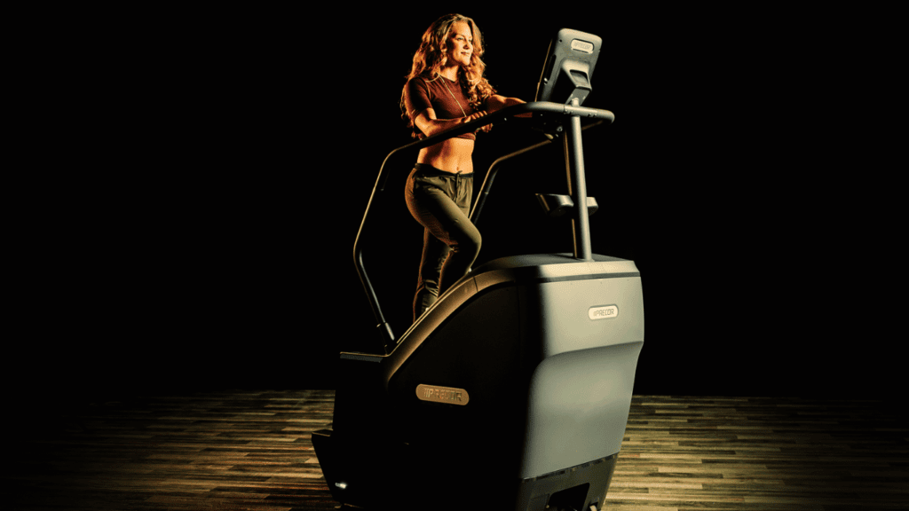 A Woman Using The Stair Climber Machine