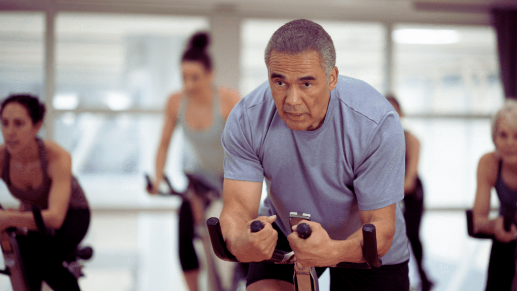 A Man Doing Spinning Class With A Stationary Bike