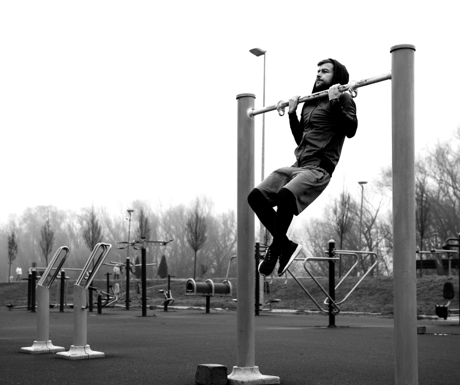 a man doing pull ups outdoor 