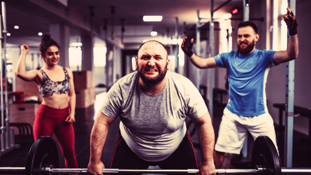 An Overweight Man With A Barbel Working Out For Back And Two People Support Him