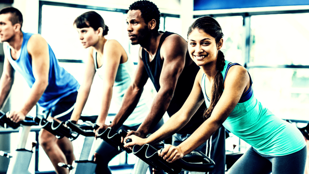 A Woman Smiling At The Camera In A Fitness Class