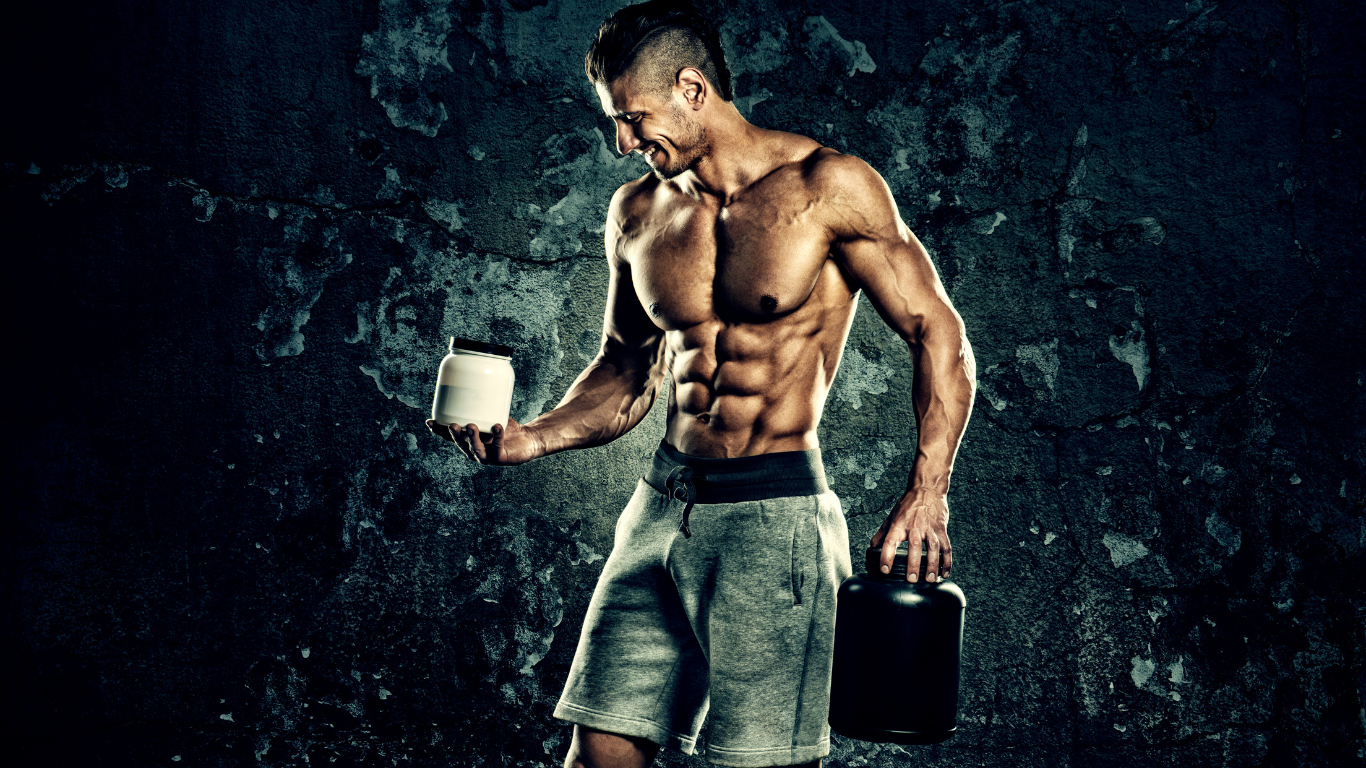 A Bodybuilder Holding Two Different Supplements 