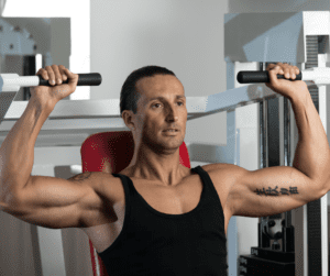 a man working out on a machine for shoulders 