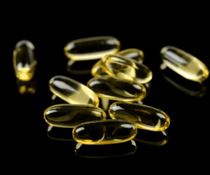 a photo with fish oil pills on a black background 