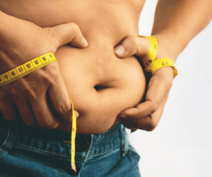 a  man measuring his belly fat