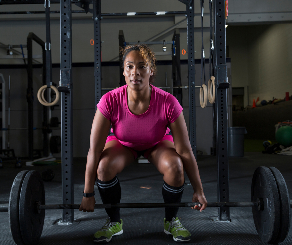 a woman powerlifter performing dead lift