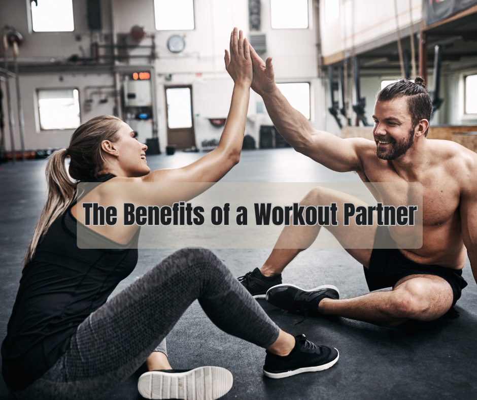 man and woman at the gym doing high five and a sign: the benefits of a workout partner