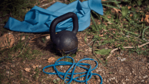 outdoor photo with kettlebell, resistance band and a yoga mat 