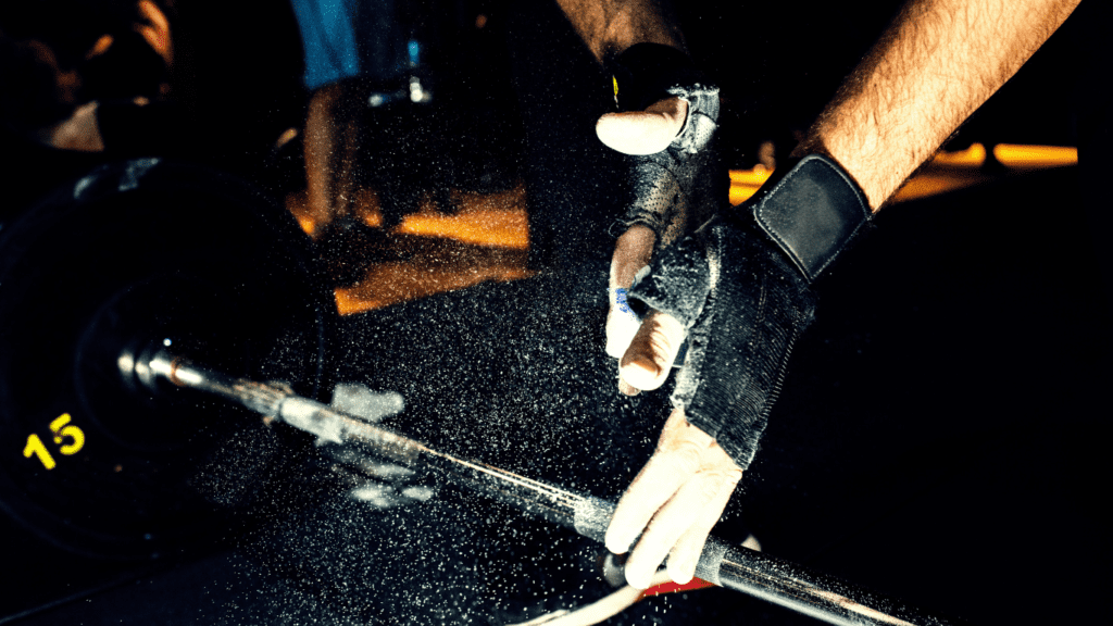 A Photo showing 2 hands ready to lift a barbel