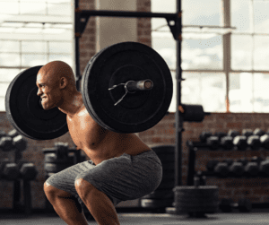 black man performing squats at the gym 