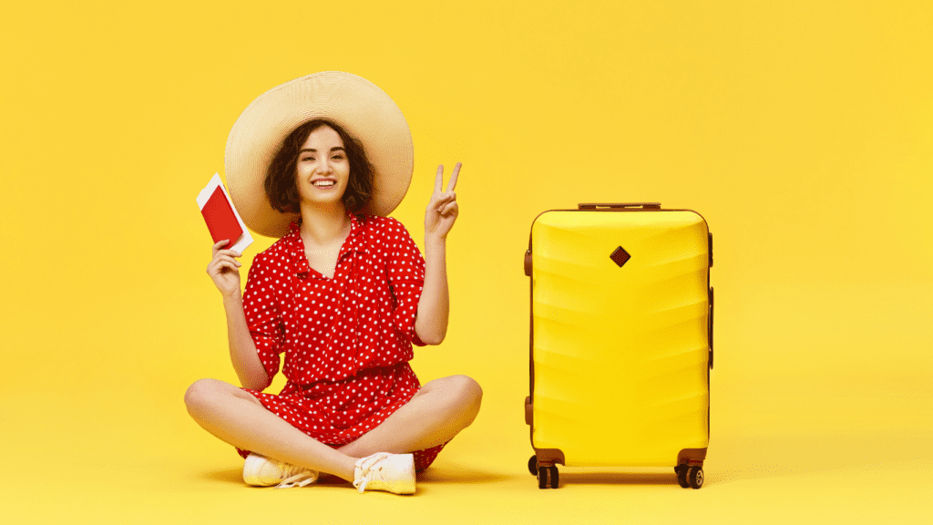 woman traveller with her luggage on a yellow photo 