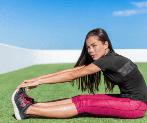 an Asian woman stretching outdoor