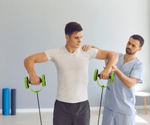 a man exercising his shoulder with a doctor and with resistance bands 