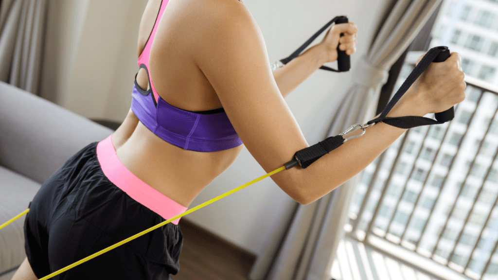 a woman at her home doing resistance bands chest workout 