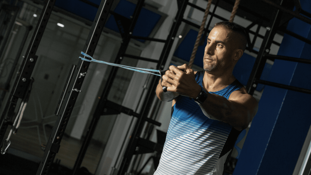 a man doing chest workout at the gym with resistance bands 