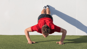 a man performs push ups for shoulder muscle 