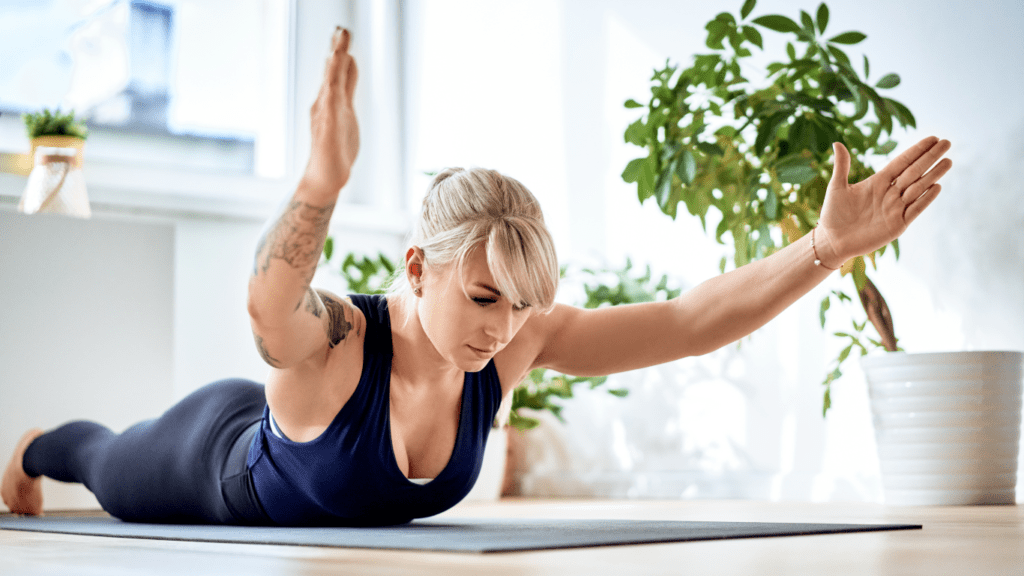 a woman performing superman exercise at home 