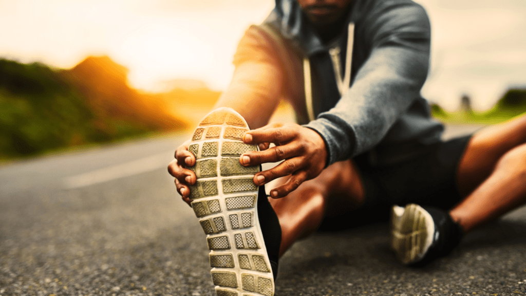 A Runner On The Road Stretching Photo