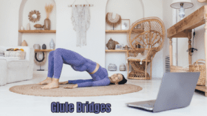 a woman doing Glute Bridges at home in front of the laptop 