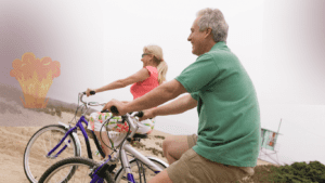 a middle aged couple cycling on a slop