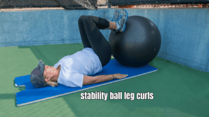 stability ball leg curls performed by a woman