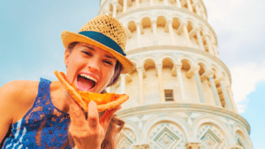 A woman eating pizza while in Italy 