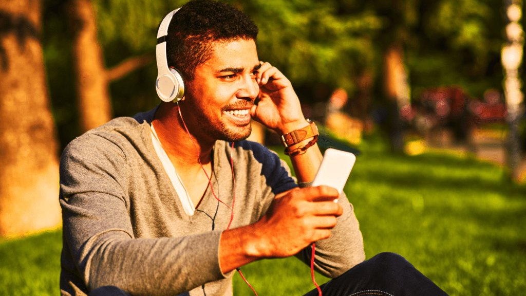 A man listening to podcast outdoors 