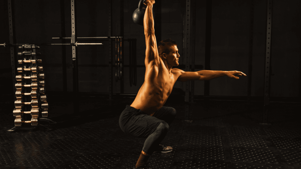 A man doing exercise with kettlebell half naked 