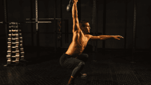 A man doing exercise with kettlebell half naked 