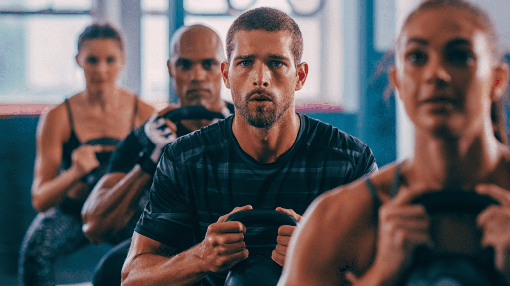 A group of people working out with kettlebells 