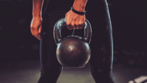 A photo showing part of a person holding kettlebell 