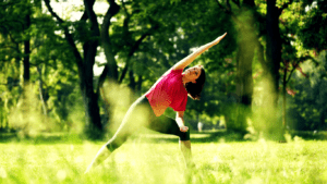 A Woman Practising Yoga By The Forest