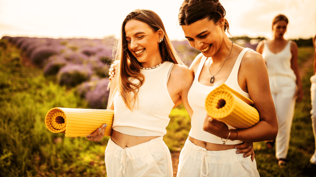 Women walking with yoga mats in the nature 