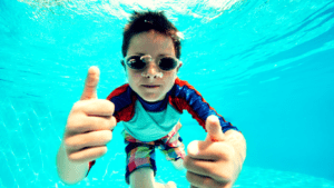 A Boy Diving Under The Water 