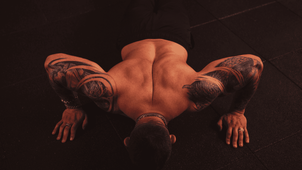 A Bodybuilder doing push ups.