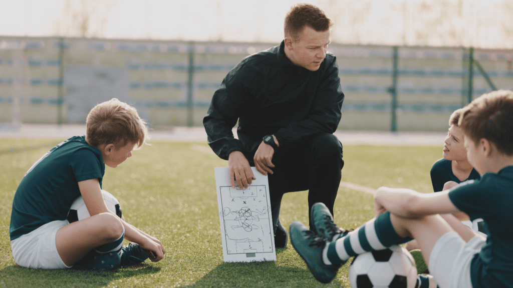 A Coach with Young Footballers 