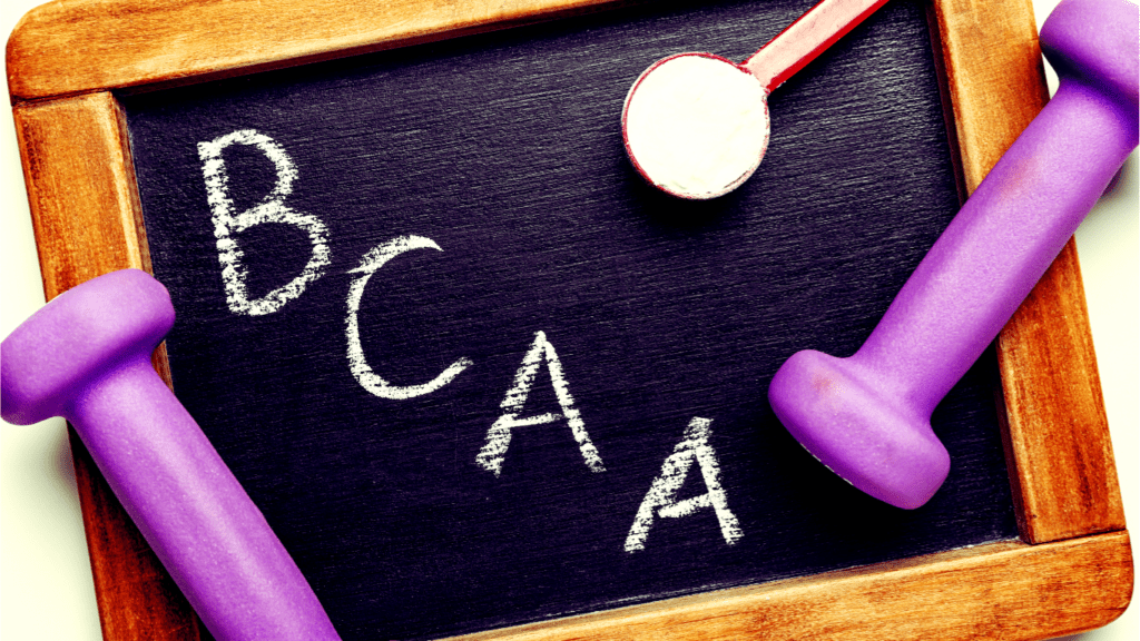 A School Board And A Sign BCAA and Two Purple Dumbbells 