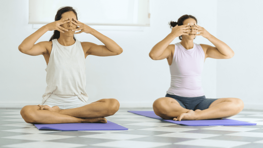 Two women doing Bhramari (Humming Bee Breath) Yoga Photo