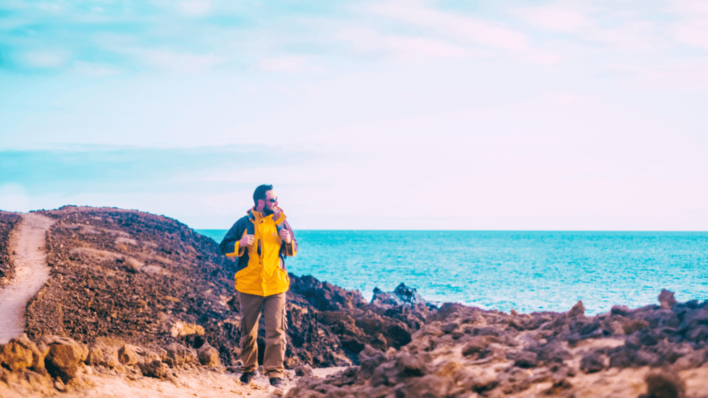 A Man Hiking By The Sea 