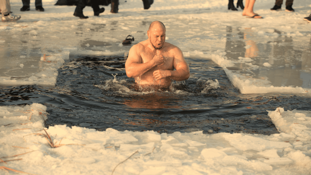 A Muscular man in a freezing water 