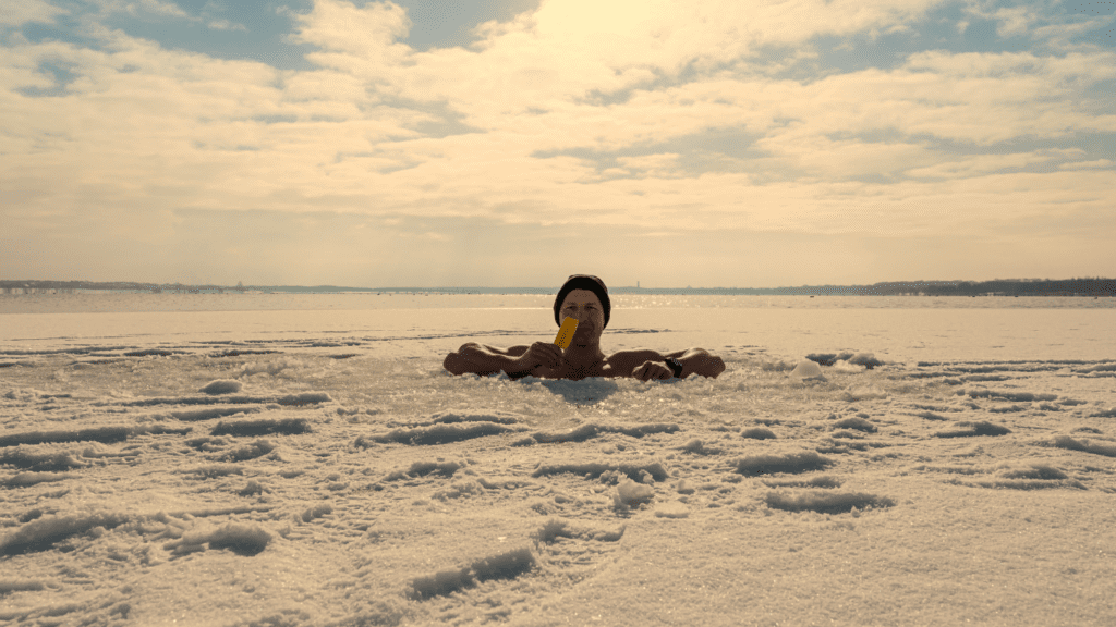 A Man Eating Ice Cream In Freezing Water 