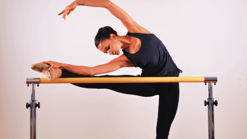 At Home Barre Workout: Flexible Barre Position Performed By A Woman In Black